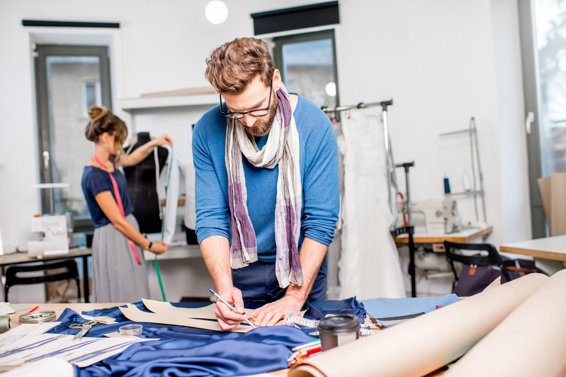 Couple of fashion designers working at the studio